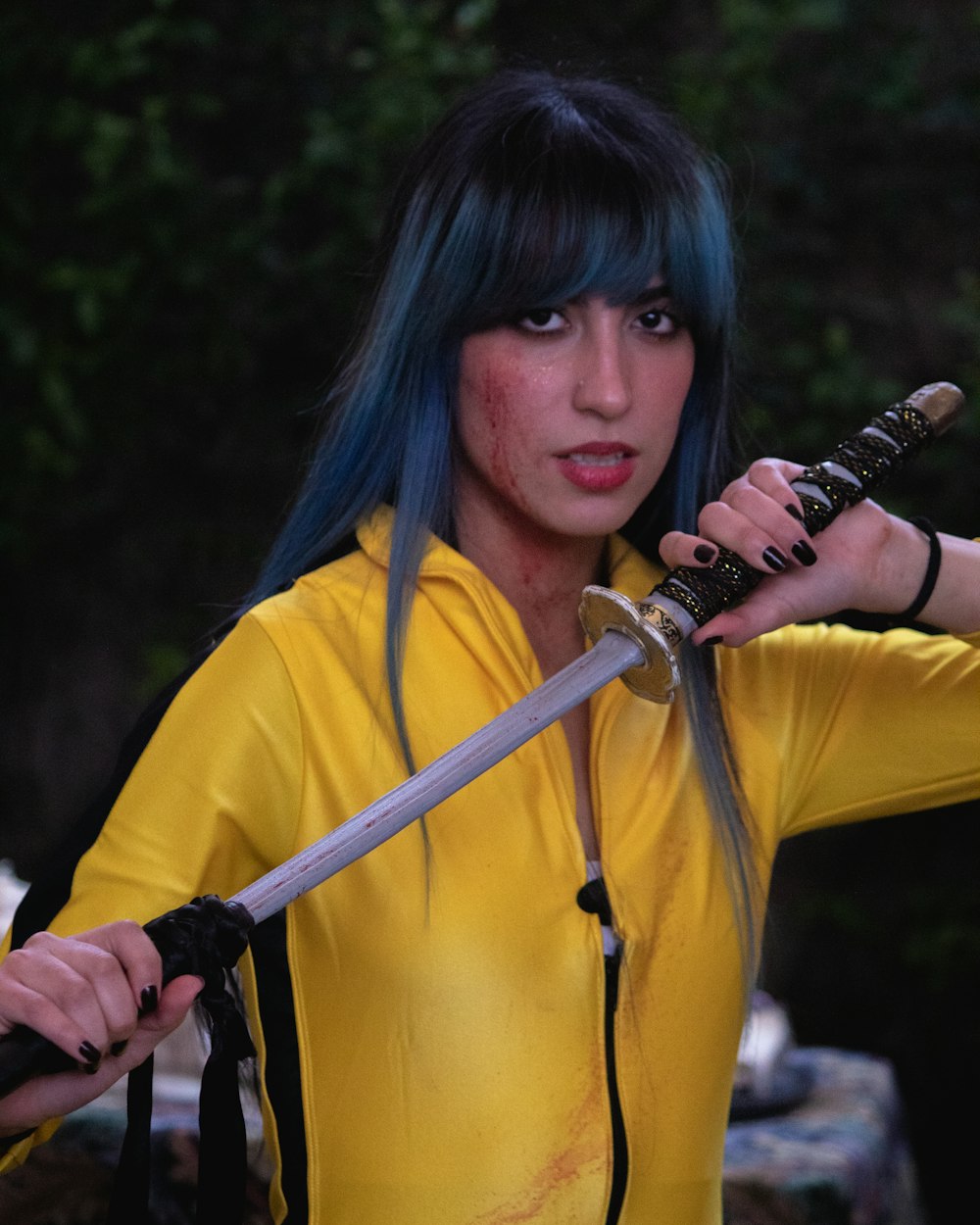 a woman with blue hair holding a sword