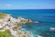 a view of the ocean from the top of a hill