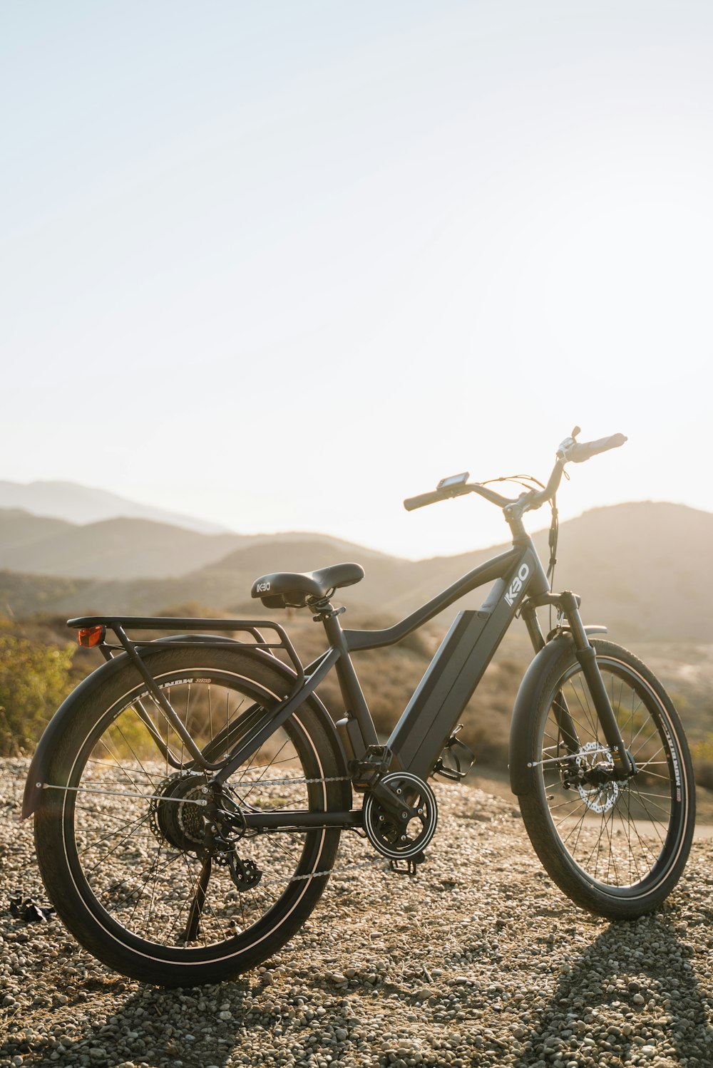 an electric bike parked on a gravel road