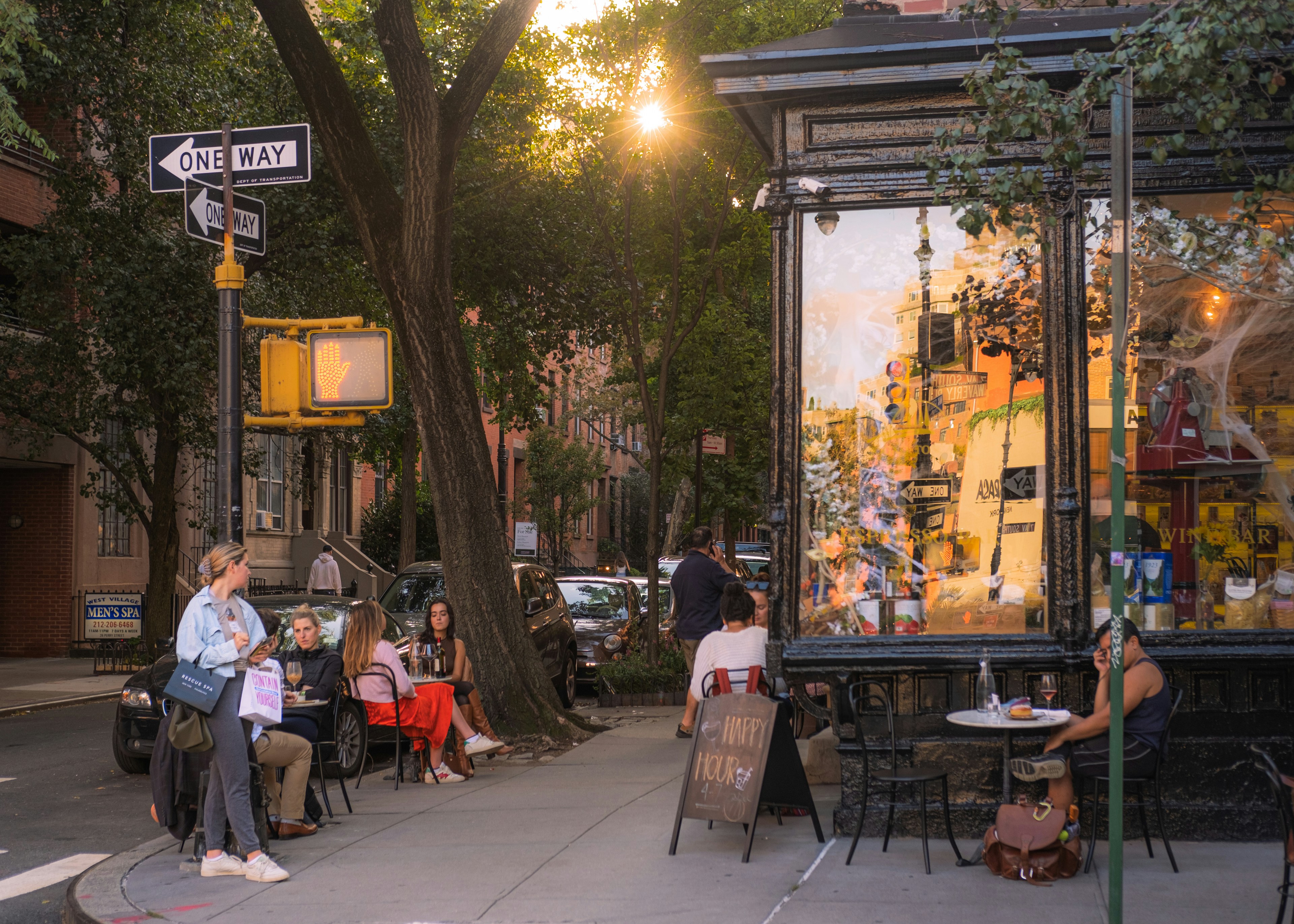 A vibrant street scene on Randolph Street's "Restaurant Row", with people dining outdoors and historic brick buildings lining the street - west loop apartment complexes