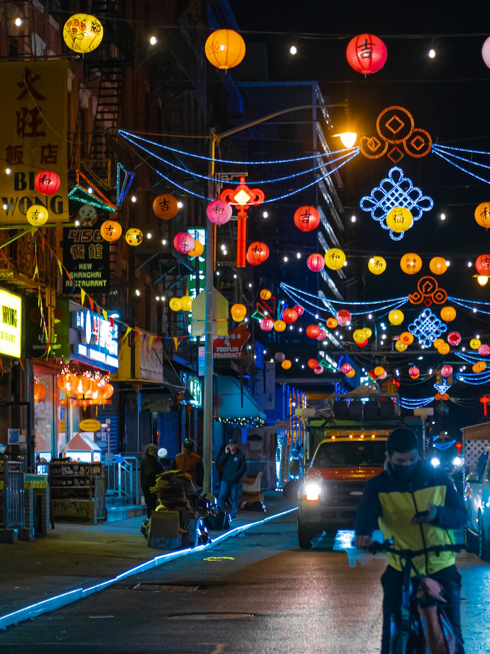 a person riding a bike down a street at night