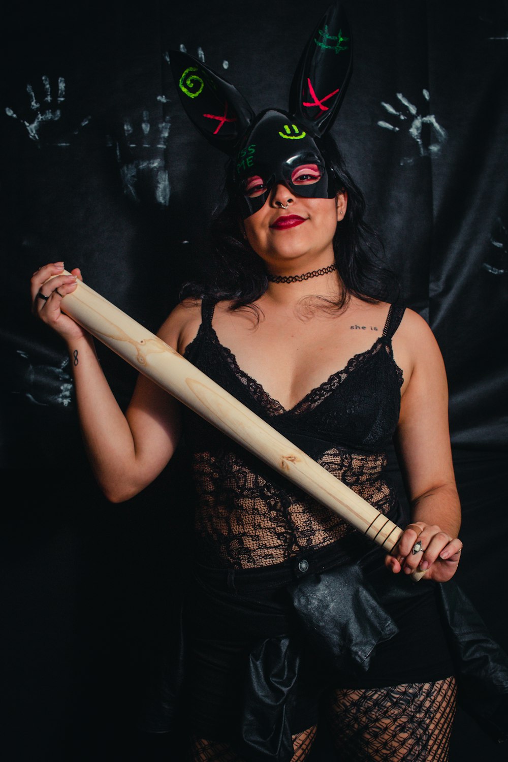 a woman in lingerie holding a baseball bat