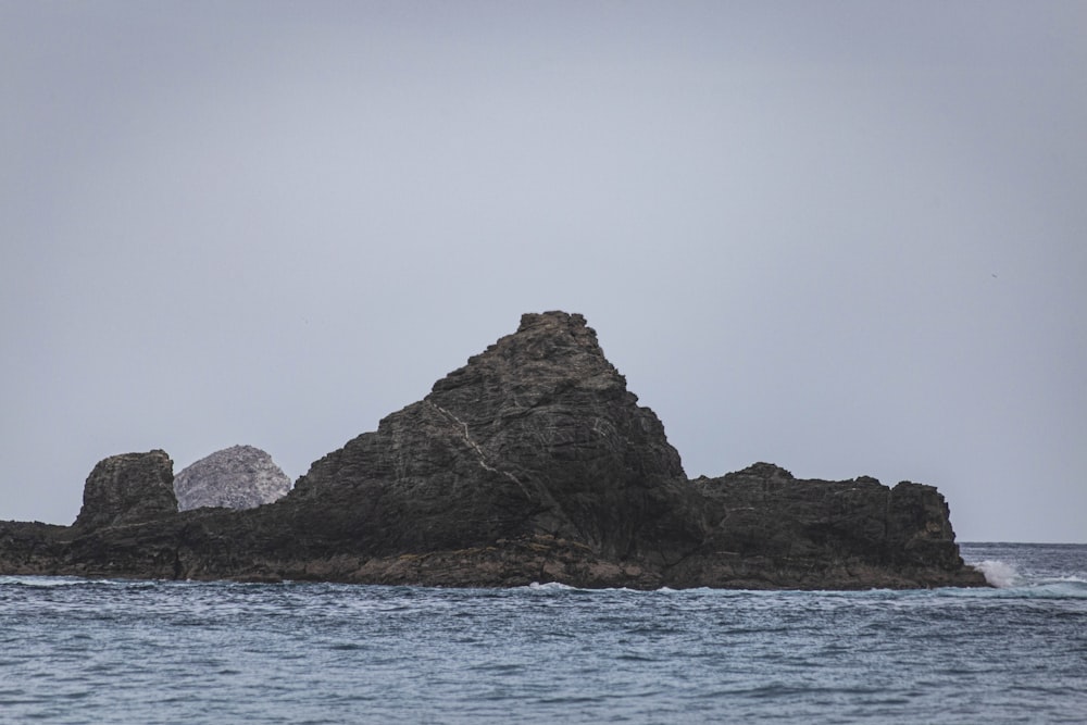 a rock outcropping in the middle of the ocean