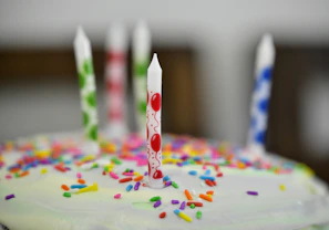 A beautifully decorated birthday cake with colorful frosting and candles.