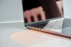 a laptop computer sitting on top of a white table