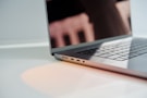 a laptop computer sitting on top of a white table