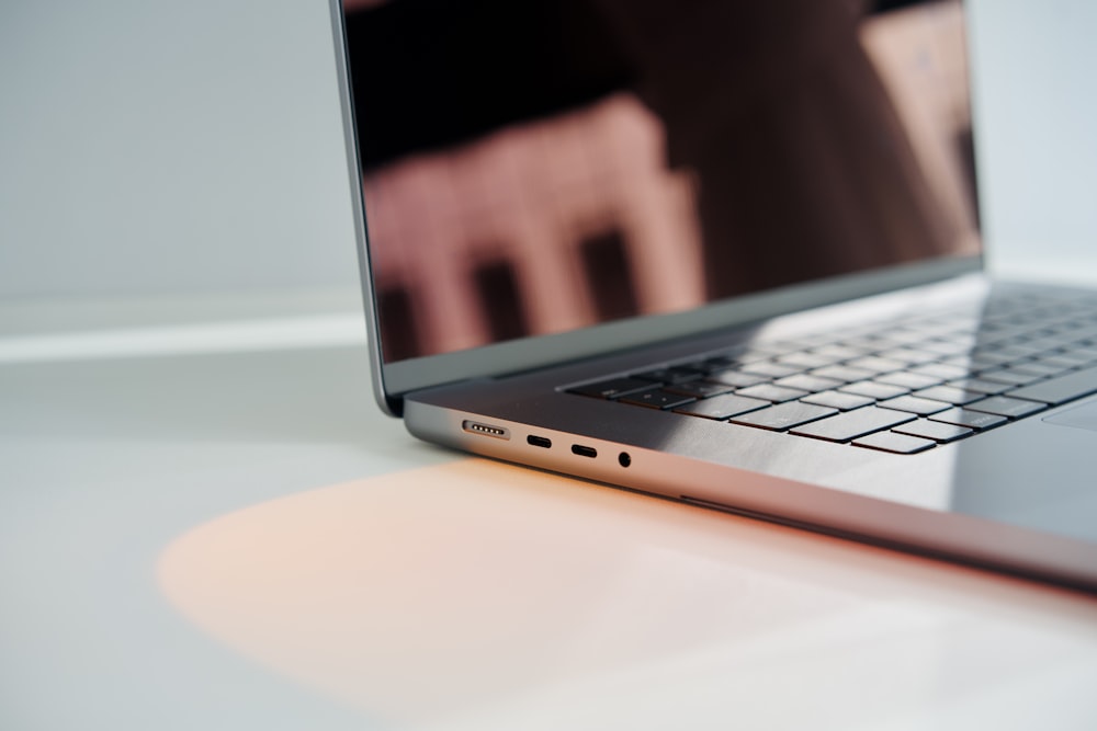 a laptop computer sitting on top of a white table