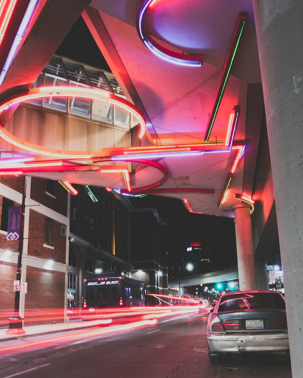 a car driving down a city street at night