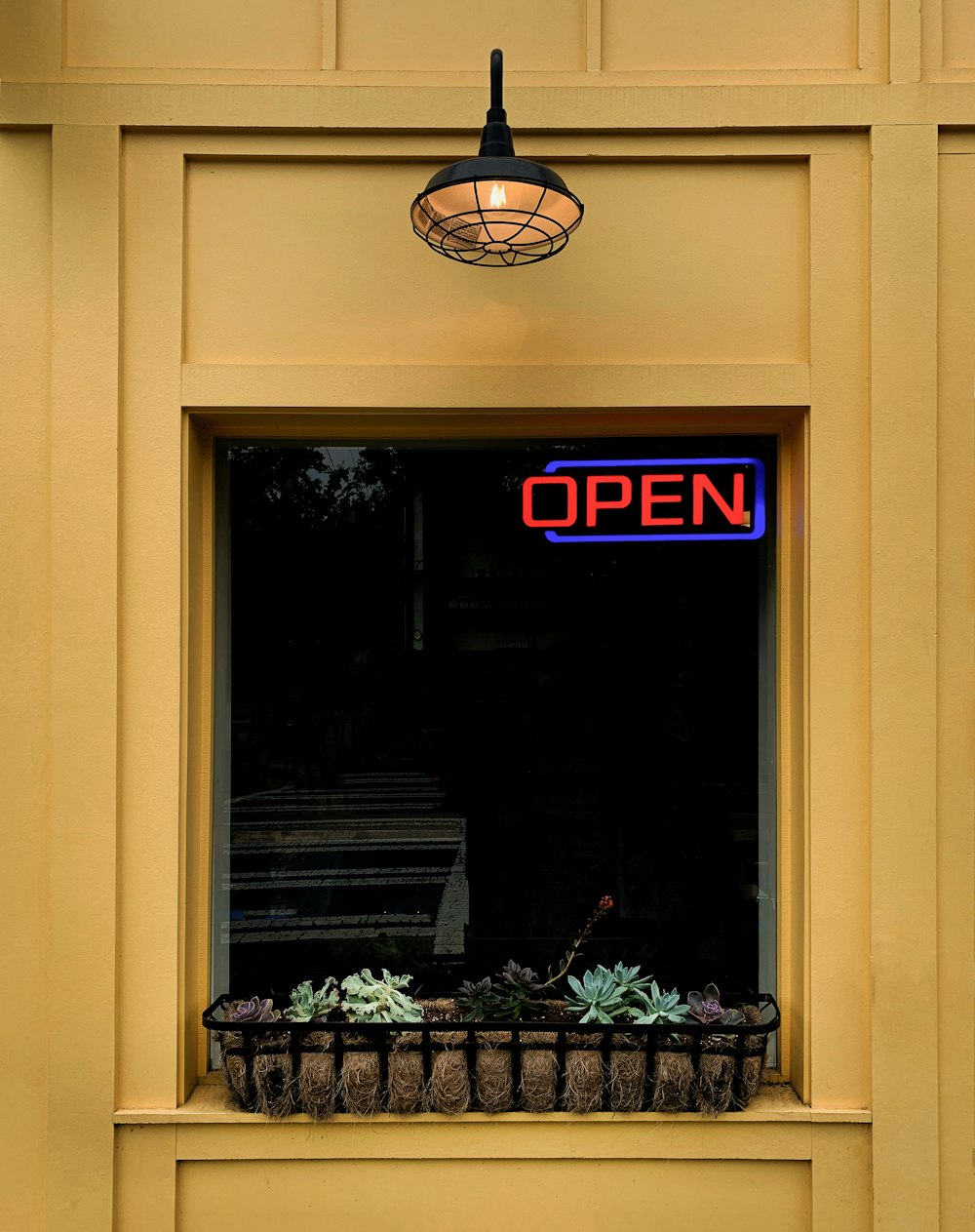 a window with a sign that reads open