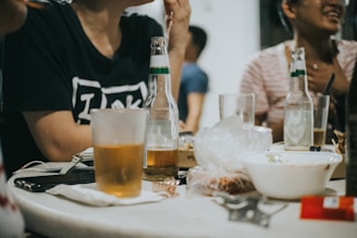 a group of people sitting around a table with drinks