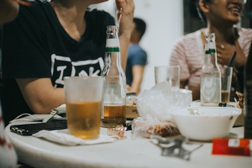 a group of people sitting around a table with drinks