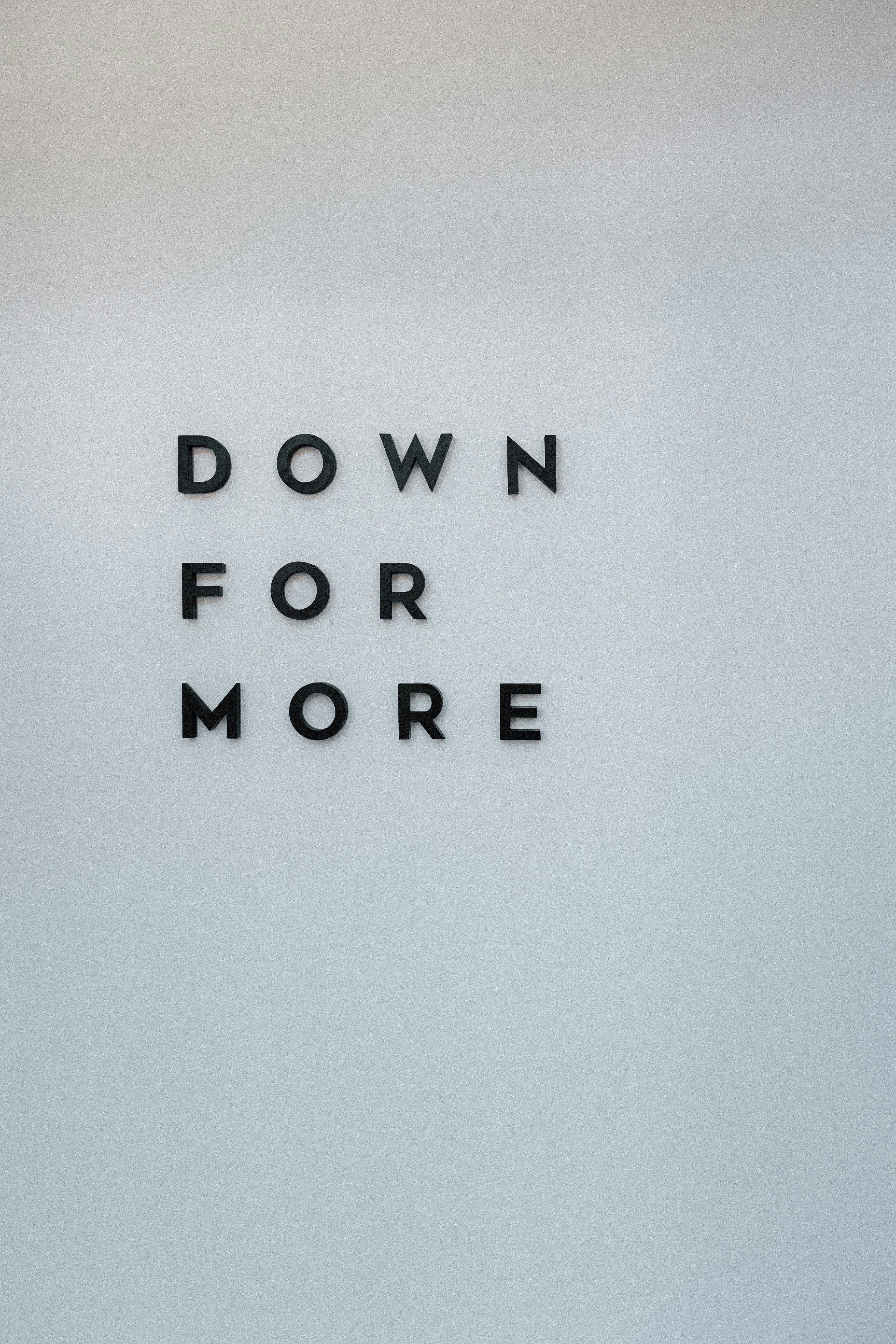 a sign that says down for more on a wall