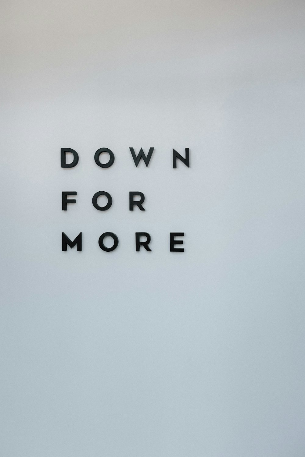 a sign that says down for more on a wall