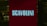 A red illuminated sign with the word 'SCAVOLINI' in bold white letters is positioned in front of what appears to be an interior setting, possibly a showroom or store. The background is dark, with some indistinct details, suggesting a dimly lit environment.