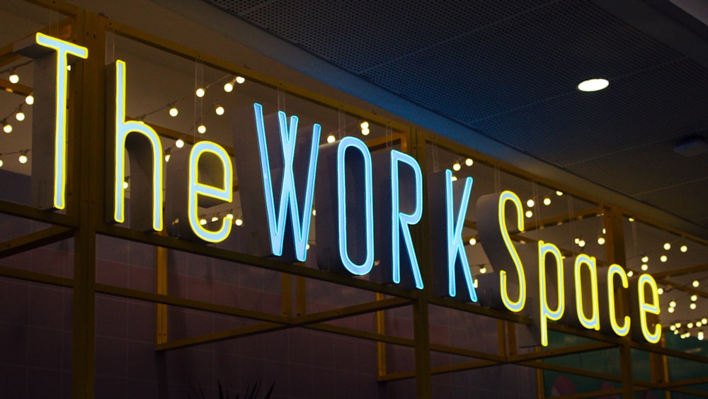 a neon sign that reads the work space