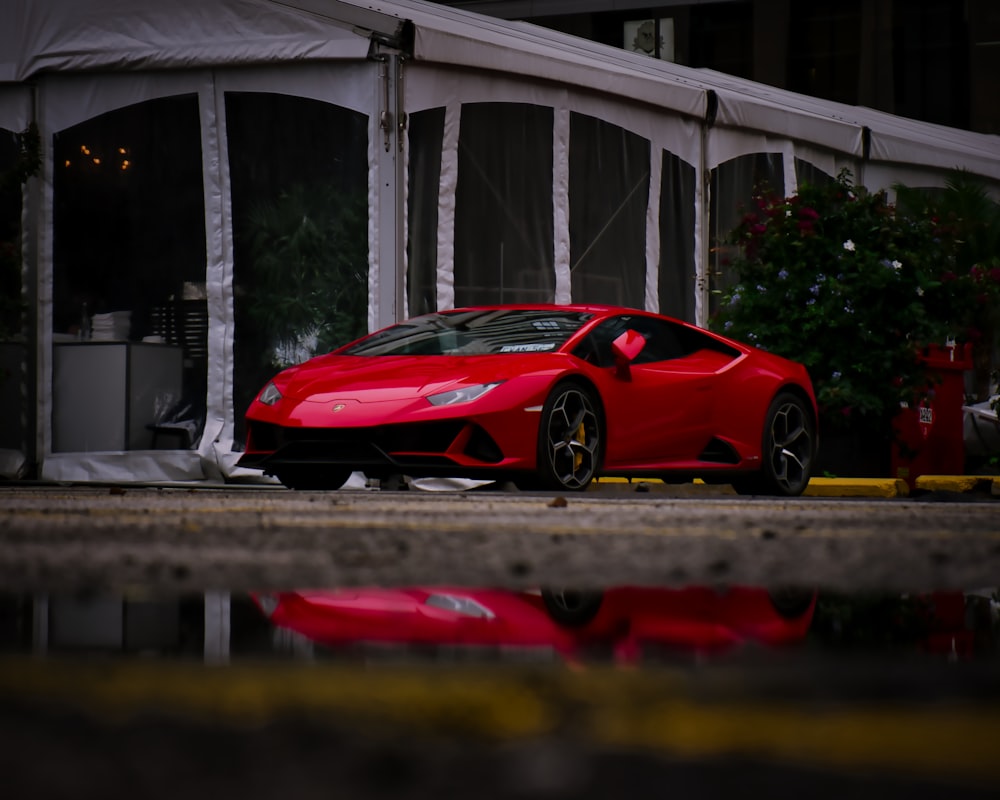 a red sports car parked in front of a building