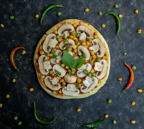 a pizza with mushrooms, peas, corn, and peas on it