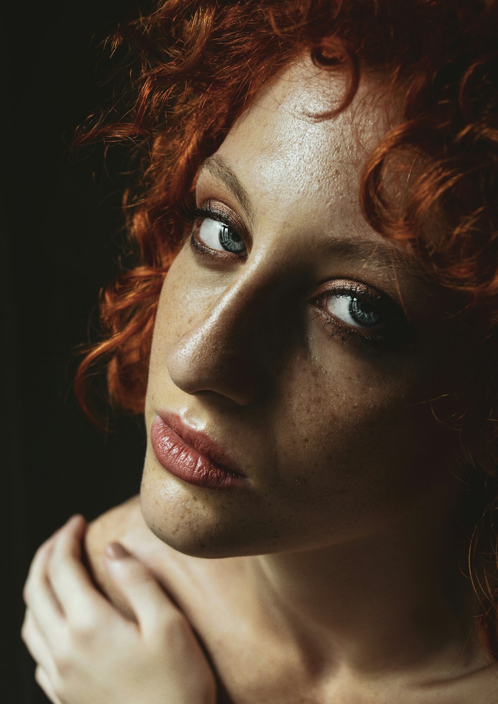 a close up of a woman with red hair