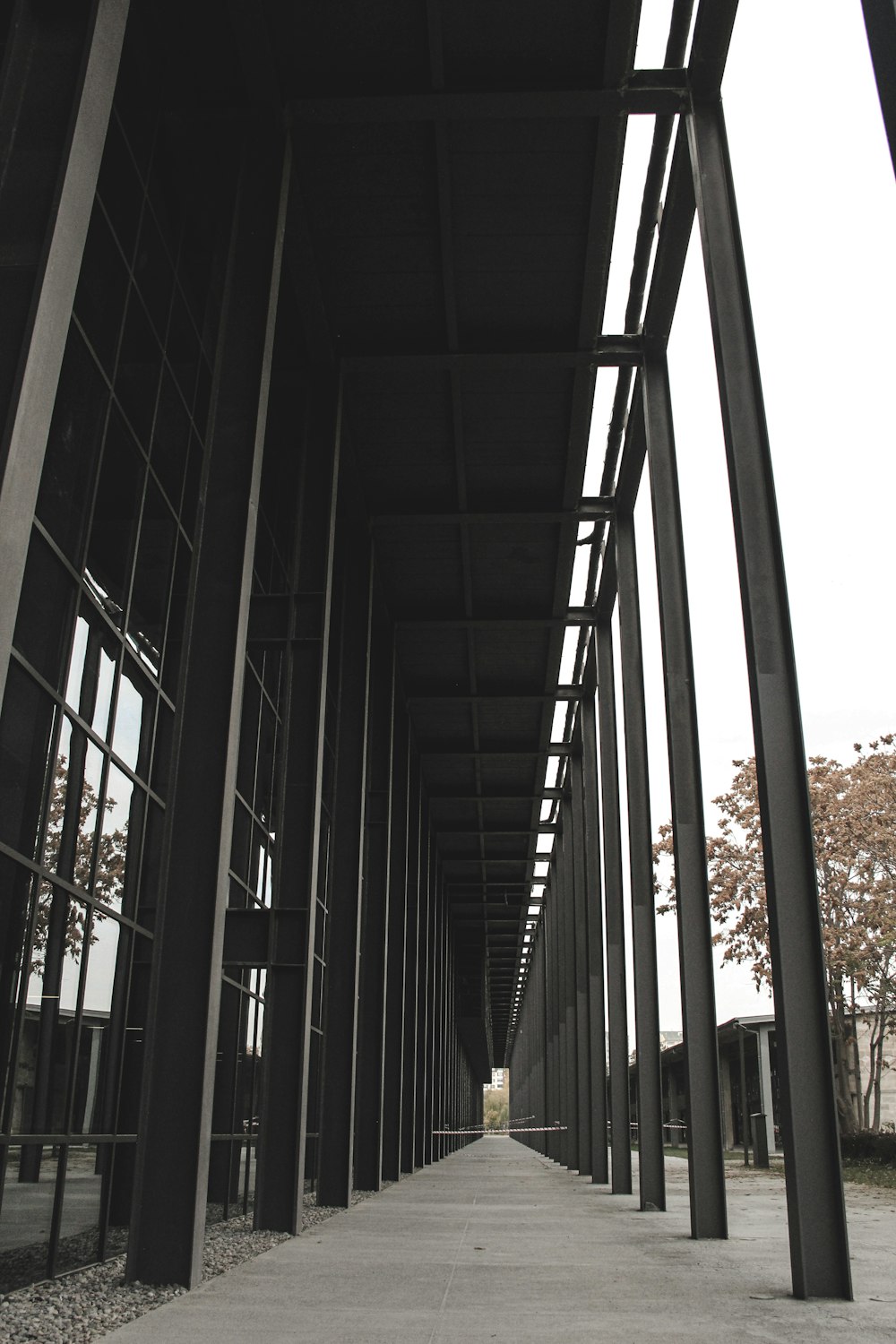 a row of black metal poles next to a building