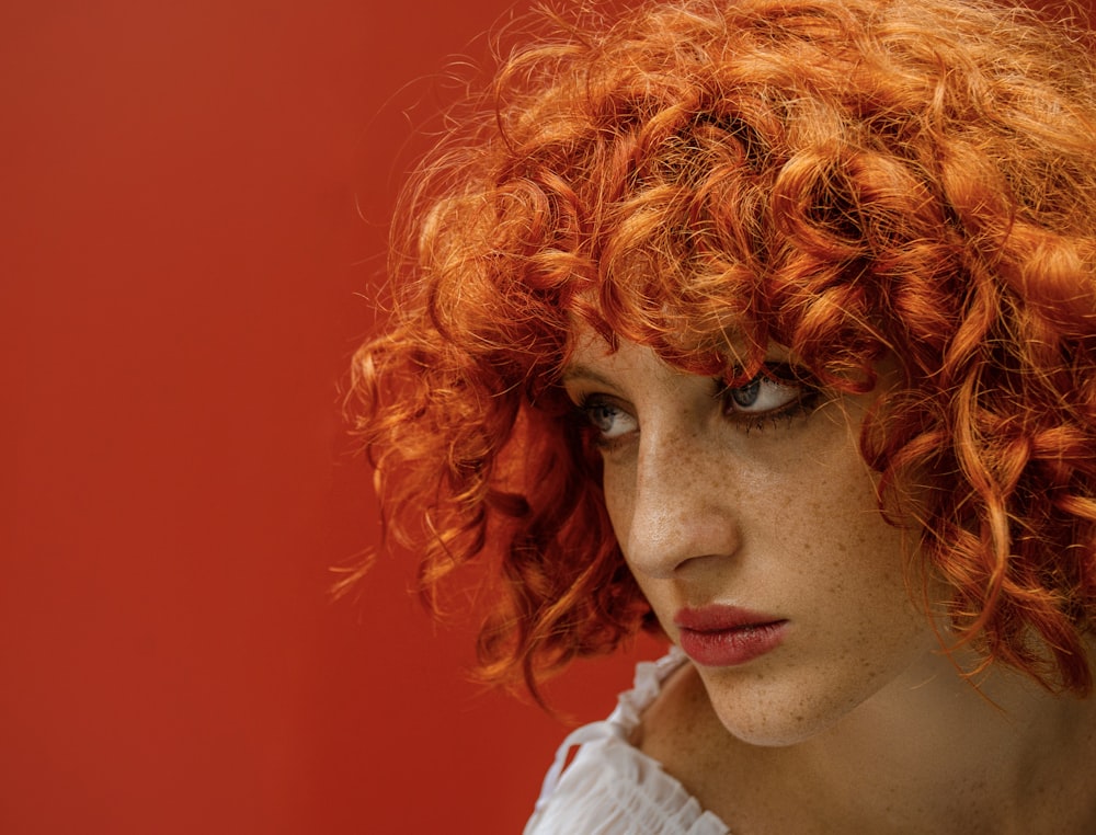 a close up of a person with red hair