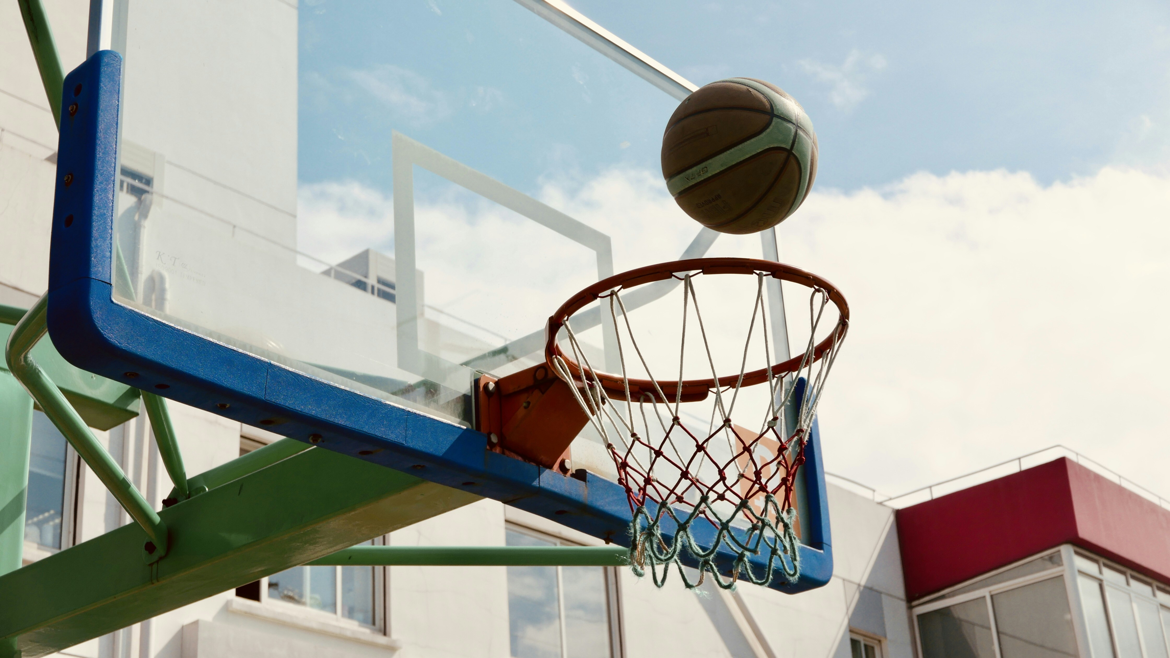 a basketball going through the hoop of a basketball court
