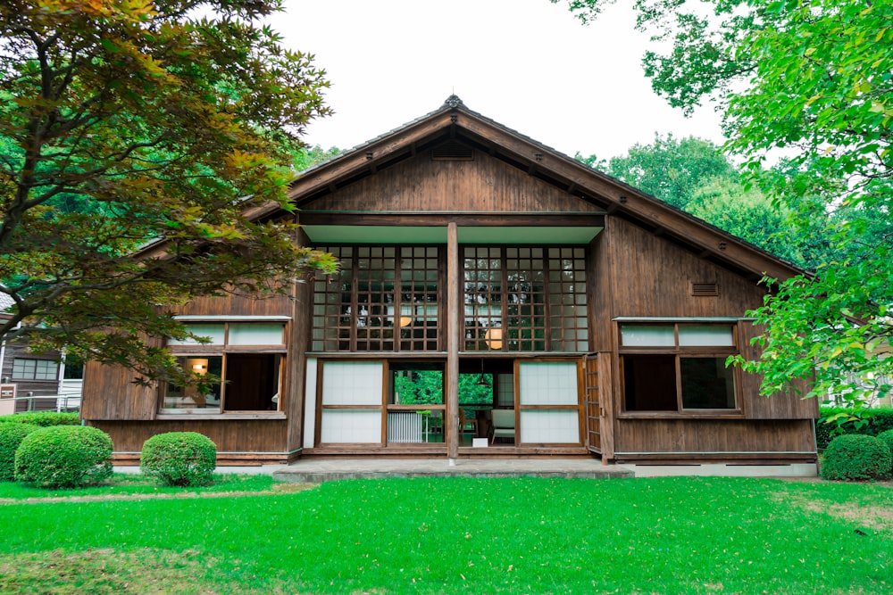 a wooden building with a green lawn in front of it