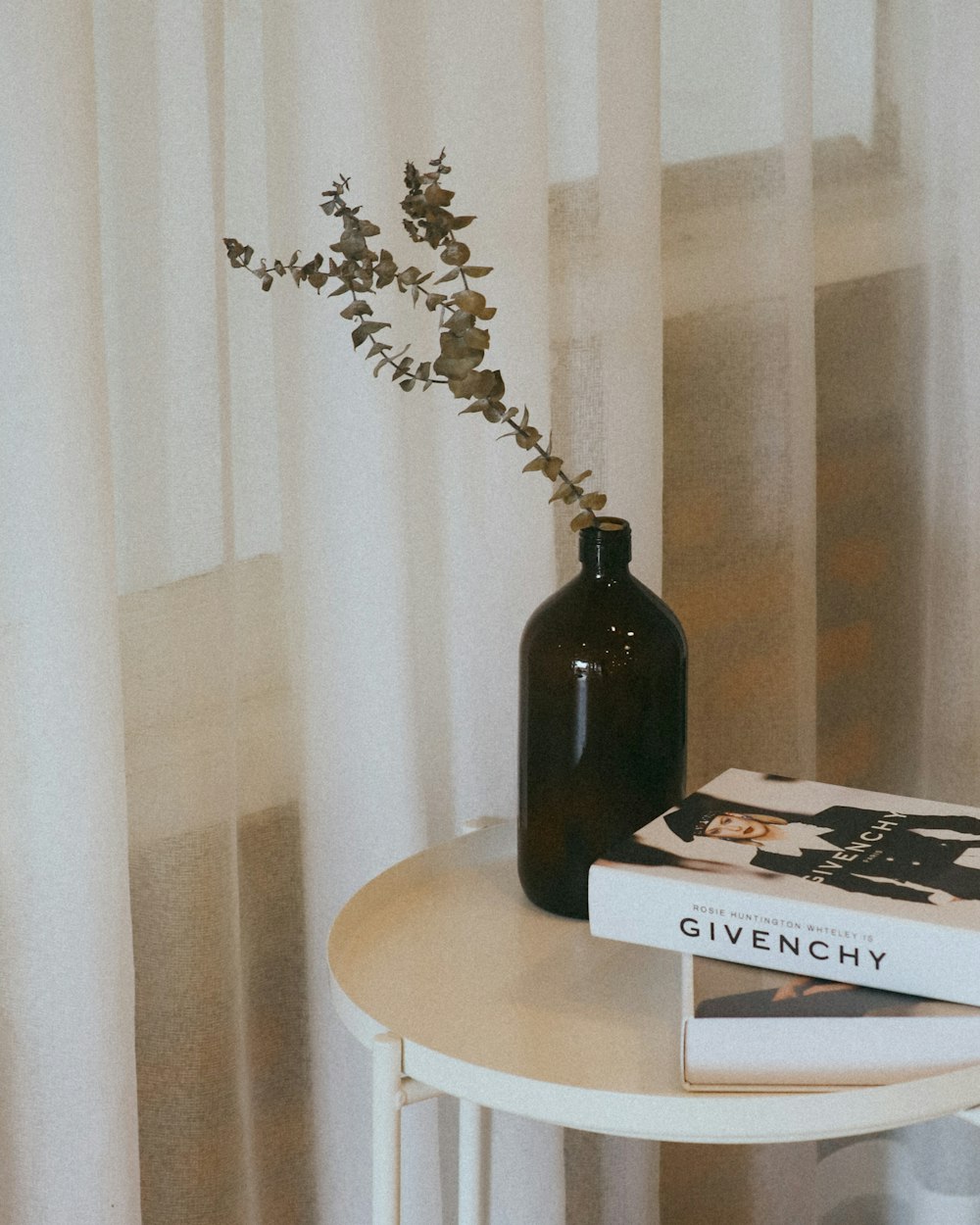 a table with a vase and a book on it