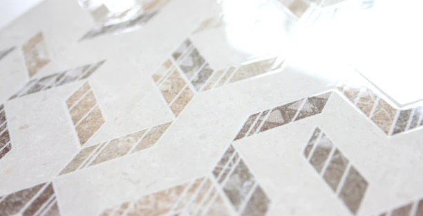 A serene, modern kitchen backsplash featuring smooth porcelain tiles in warm taupe tones.