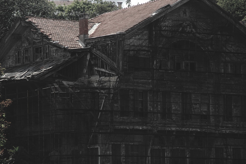 an old wooden house with a clock tower in the background