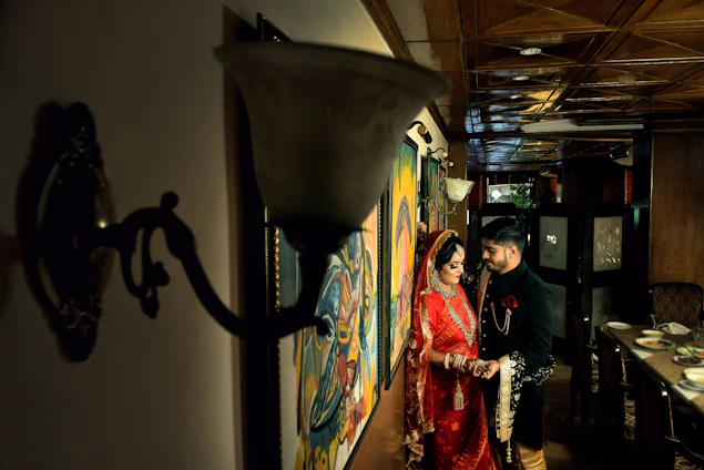 A stylish Indian man and woman modeling vibrant traditional and modern clothing side by side.