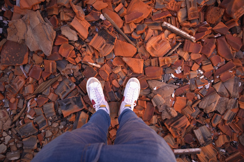 a person standing on top of a pile of rocks