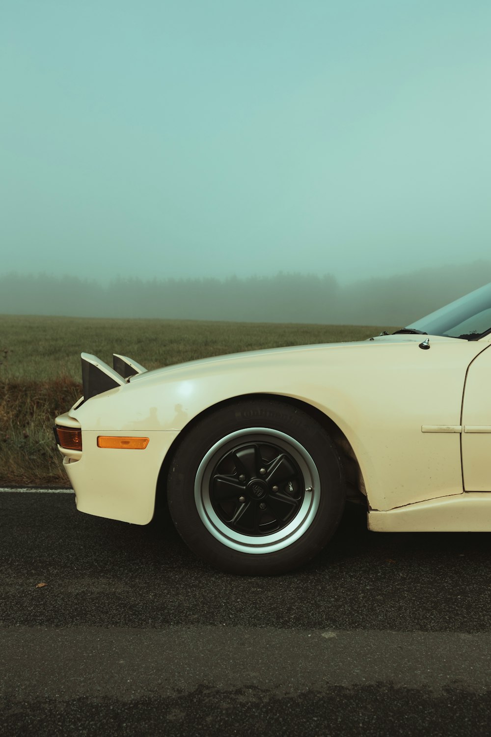 a white sports car parked on the side of the road