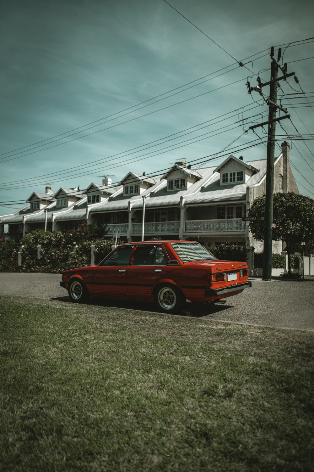 a red car parked in front of a building