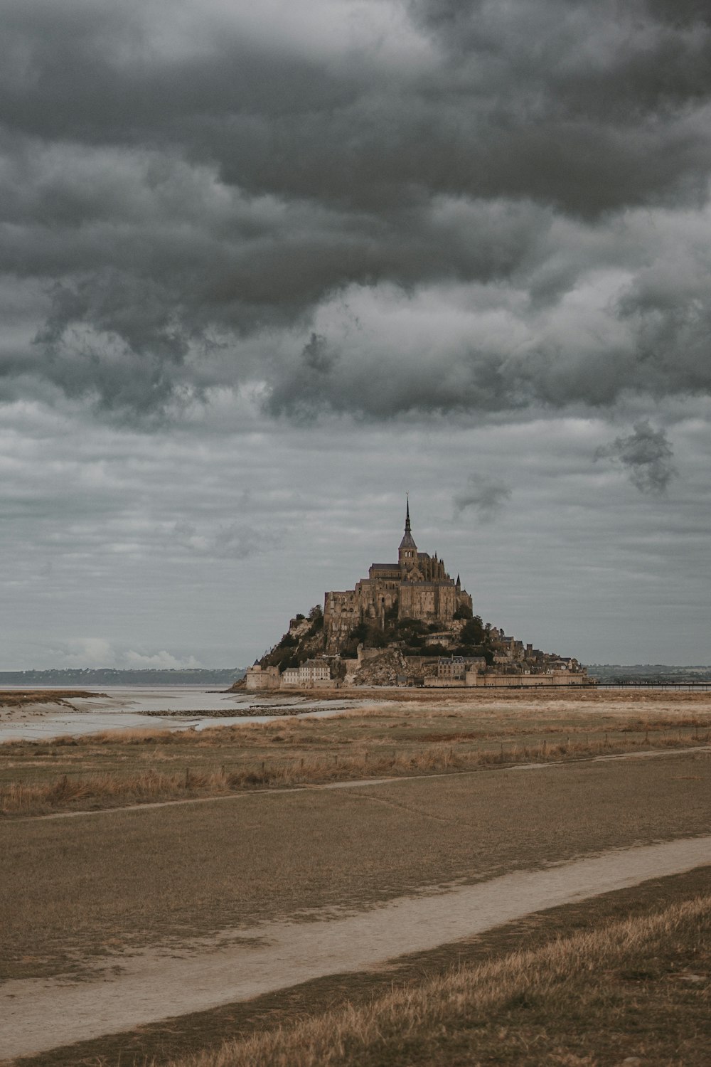 a large castle sitting on top of a sandy beach