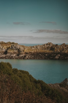 A serene coastal trail overlooking turquoise waters and rocky cliffs in Sardinia.