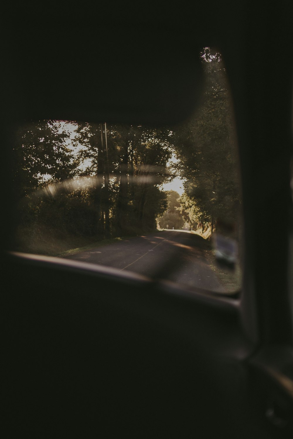 a view of a road through a car window