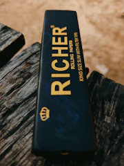 Close-up of premium rolling papers and filter tips arranged neatly on the fold-out tray.