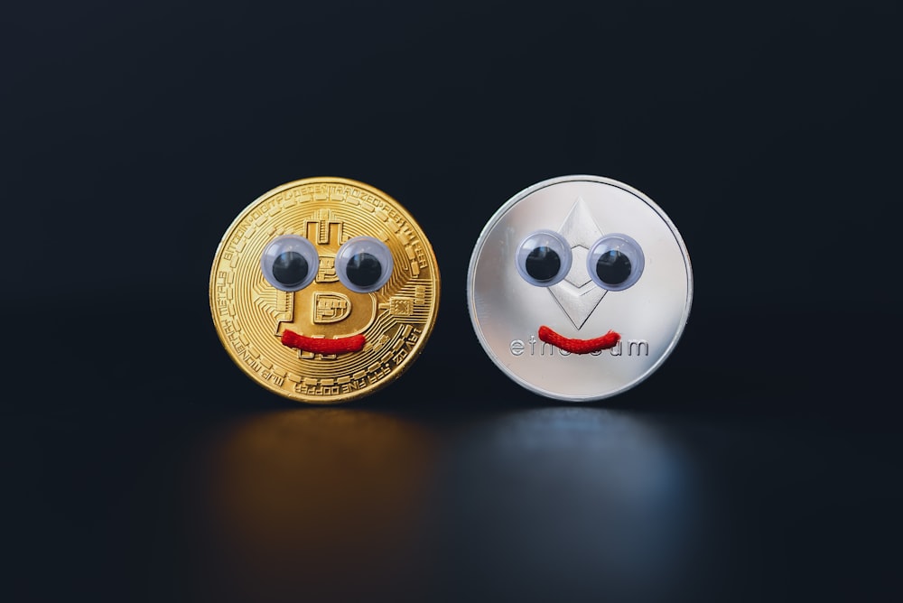 a bitcoin and a coin with eyes