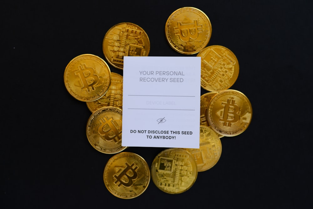 a pile of gold bitcoins sitting on top of a table