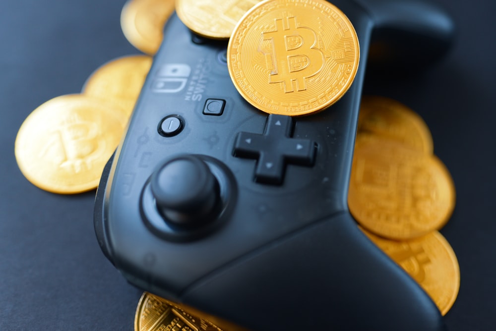 a video game controller surrounded by bitcoins