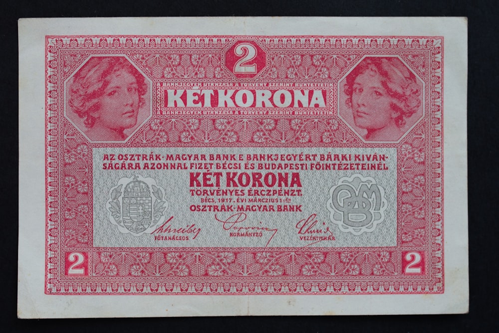 a red and white paper money with a picture of a woman