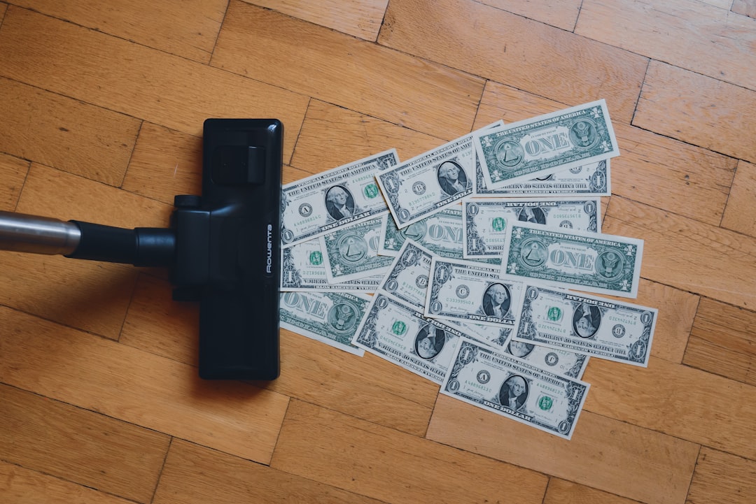 a pile of money sitting on top of a wooden floor,