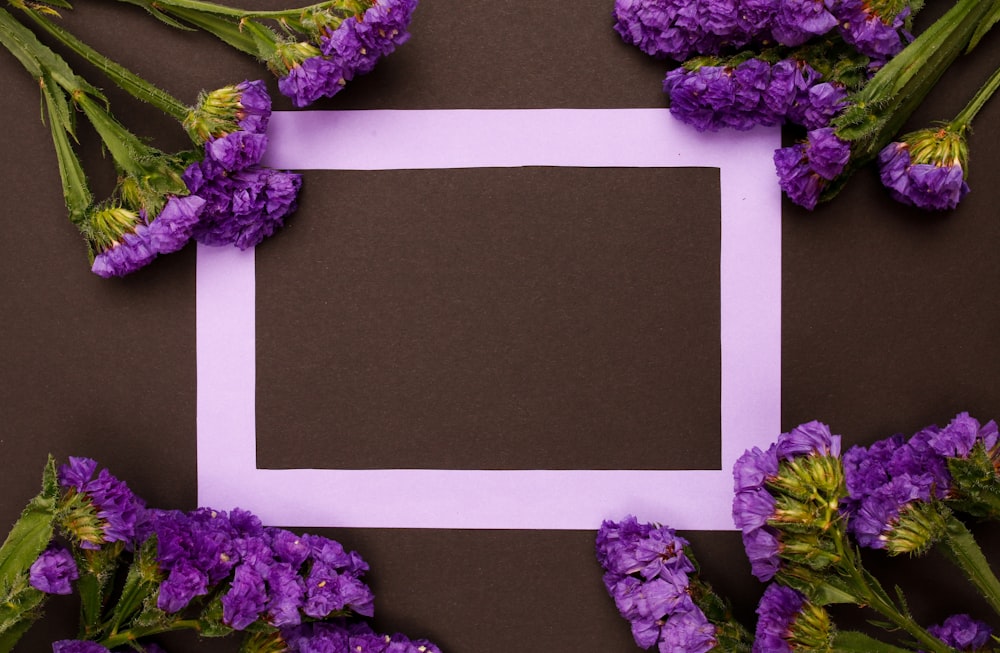 a picture frame surrounded by purple flowers