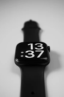 a black apple watch with white numbers on it