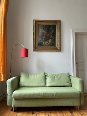 A cozy living room featuring a vibrant wall art painting from muralis above the sofa.