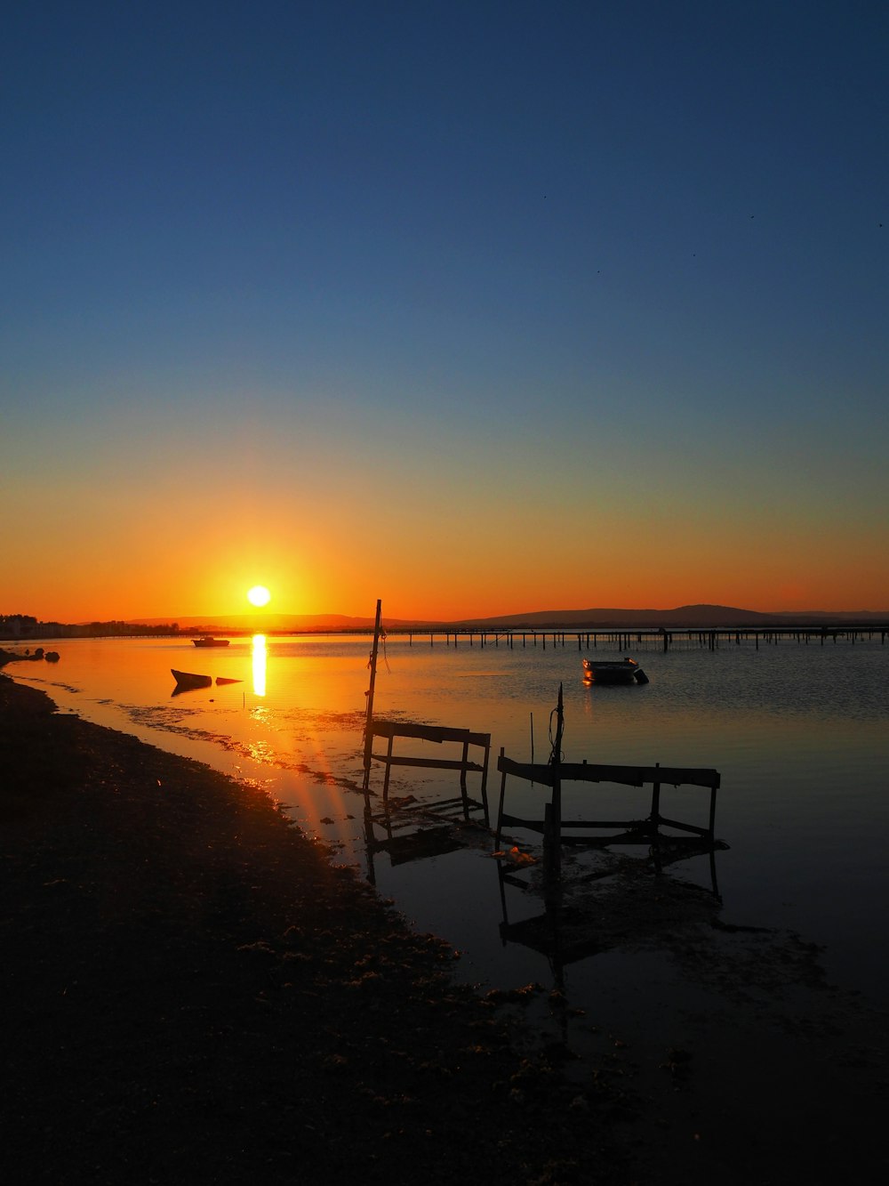 the sun is setting over a body of water