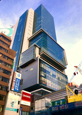 A modern real estate team showing vibrant city views through office windows in Japan.