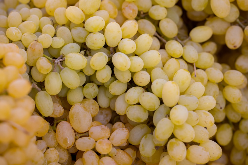a bunch of grapes that are yellow in color