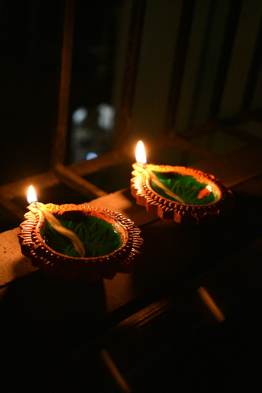 a couple of small candles sitting on top of a table