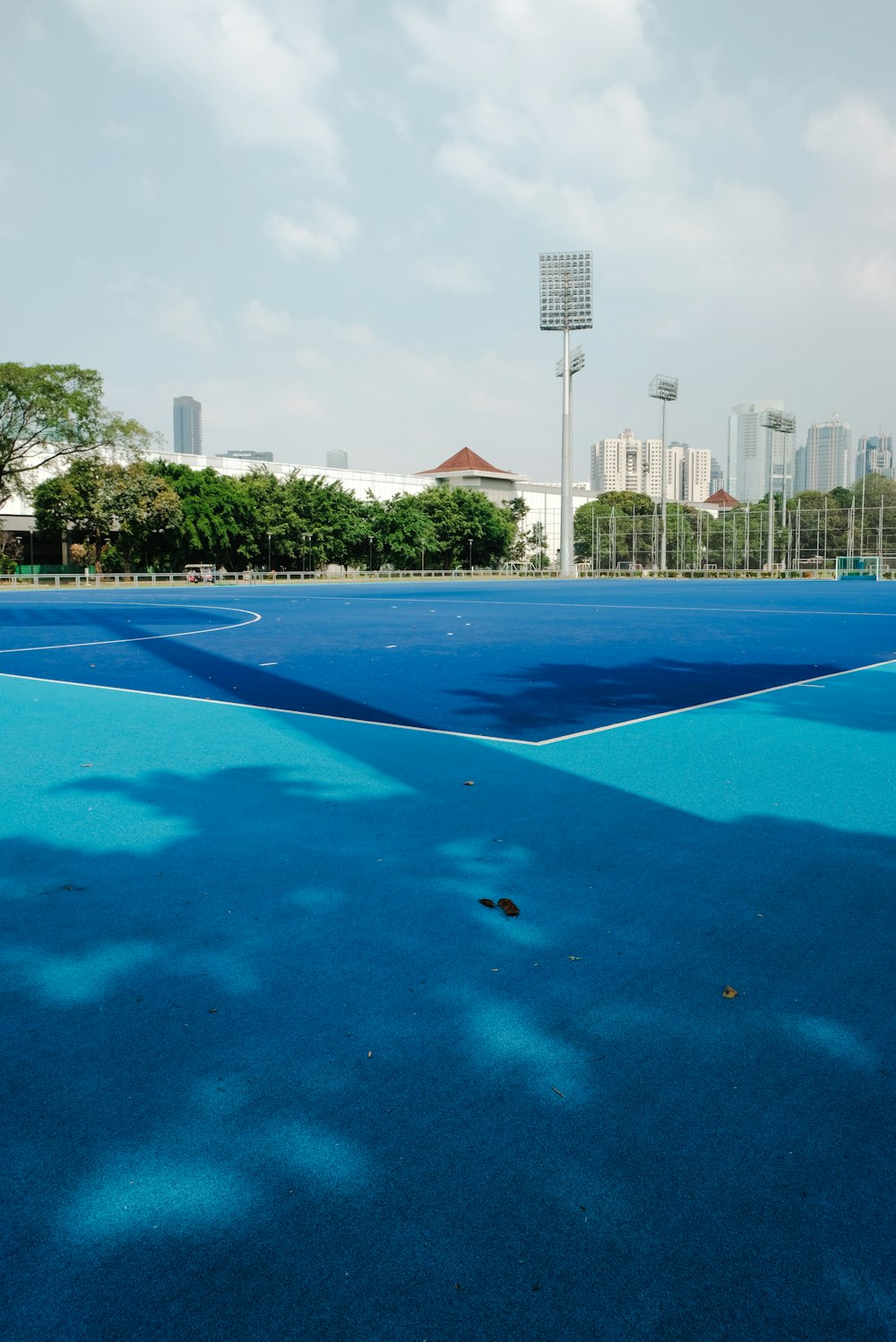 a blue tennis court with a sky background